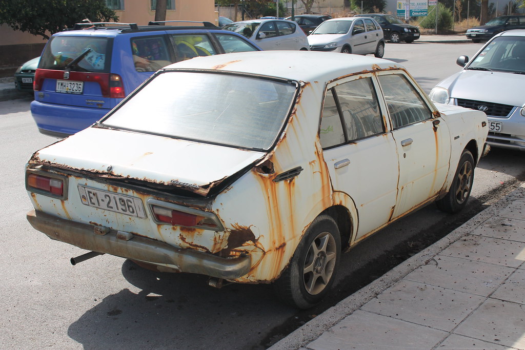 Beschädigtes Auto auf Parkplatz mit Delle an der Tür